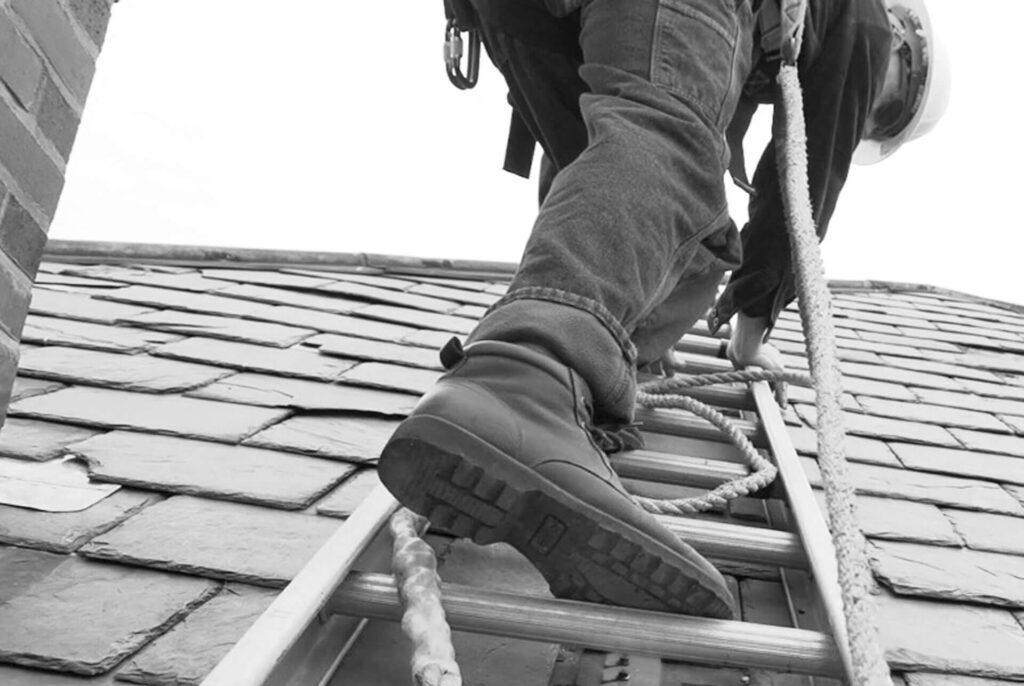 Roof inspector on top of roof