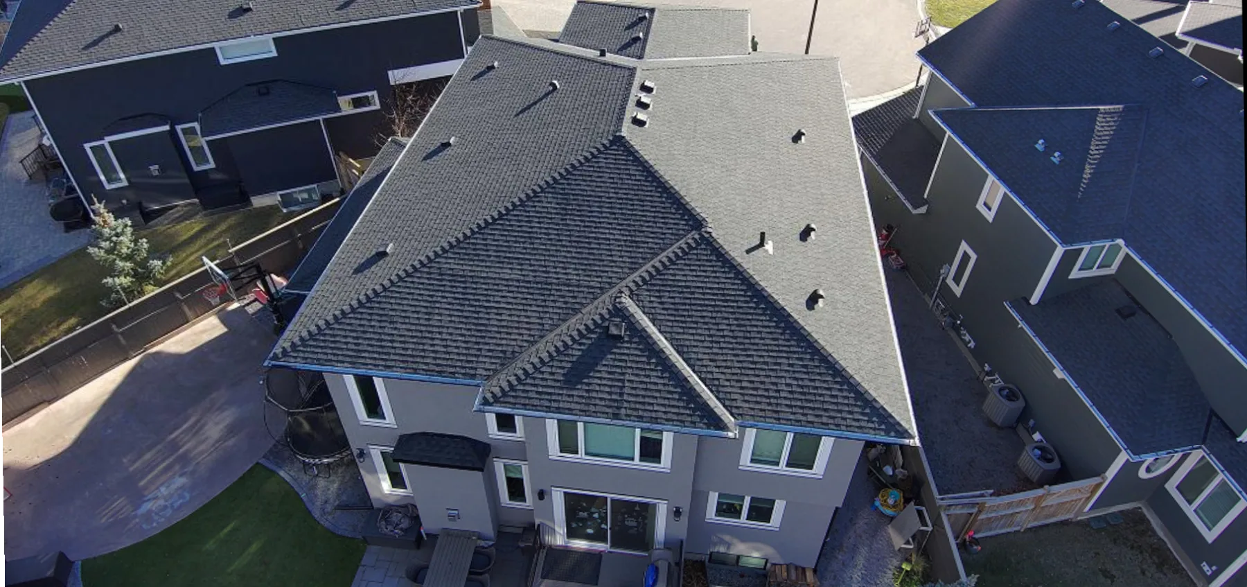 New shingle roof on a two-storey home in Aspen Woods, Calgary, seen from above