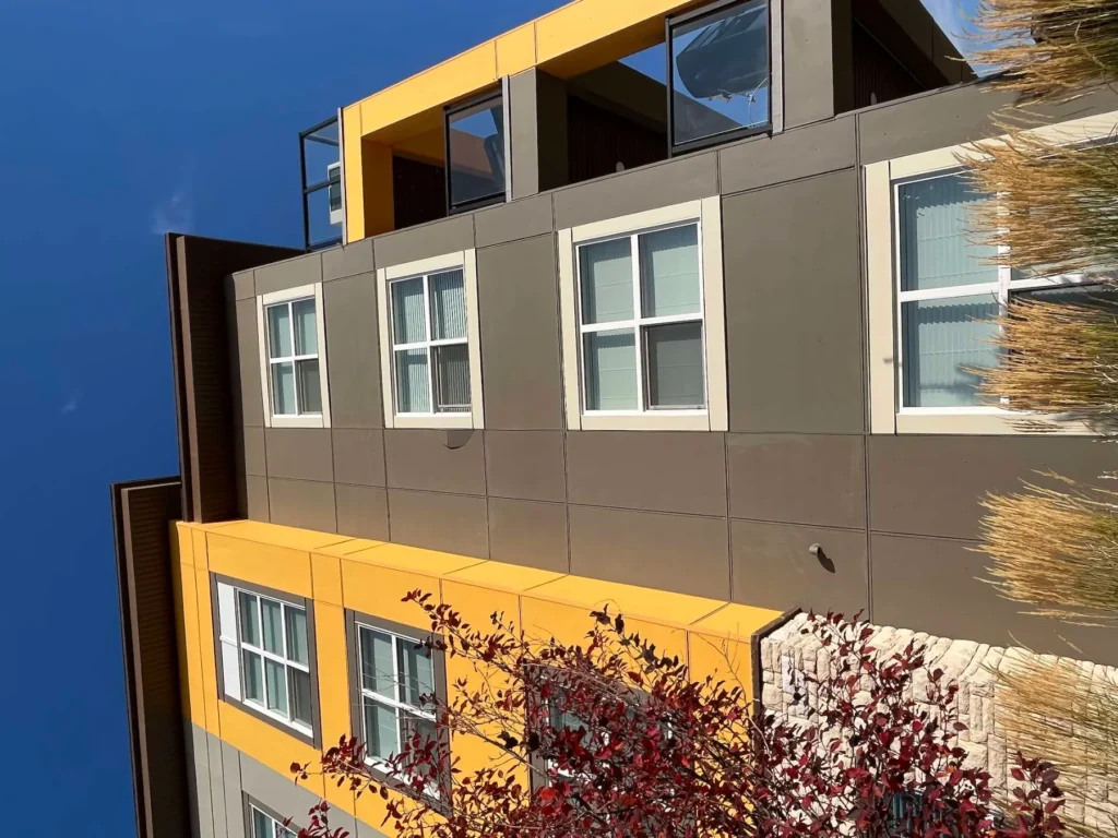 Upper floors and roofline of a Calgary condo building after soffit work
