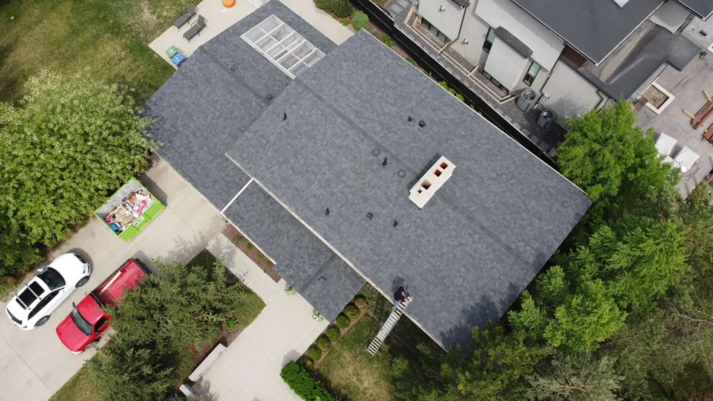 Finished grey architectural shingle roof on an inner southwest Calgary home, drone view