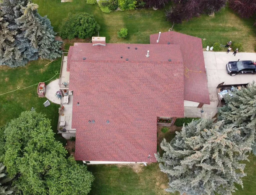 Finished red architectural shingle roof on a Dalhousie, Calgary home, top-down drone view