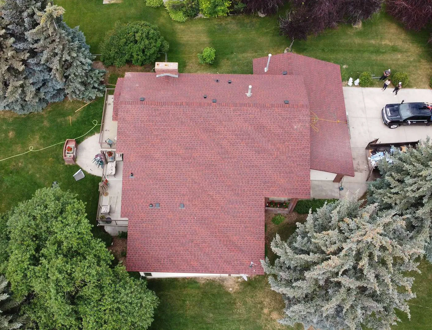 Finished red architectural shingle roof on a Dalhousie, Calgary home, top-down drone view