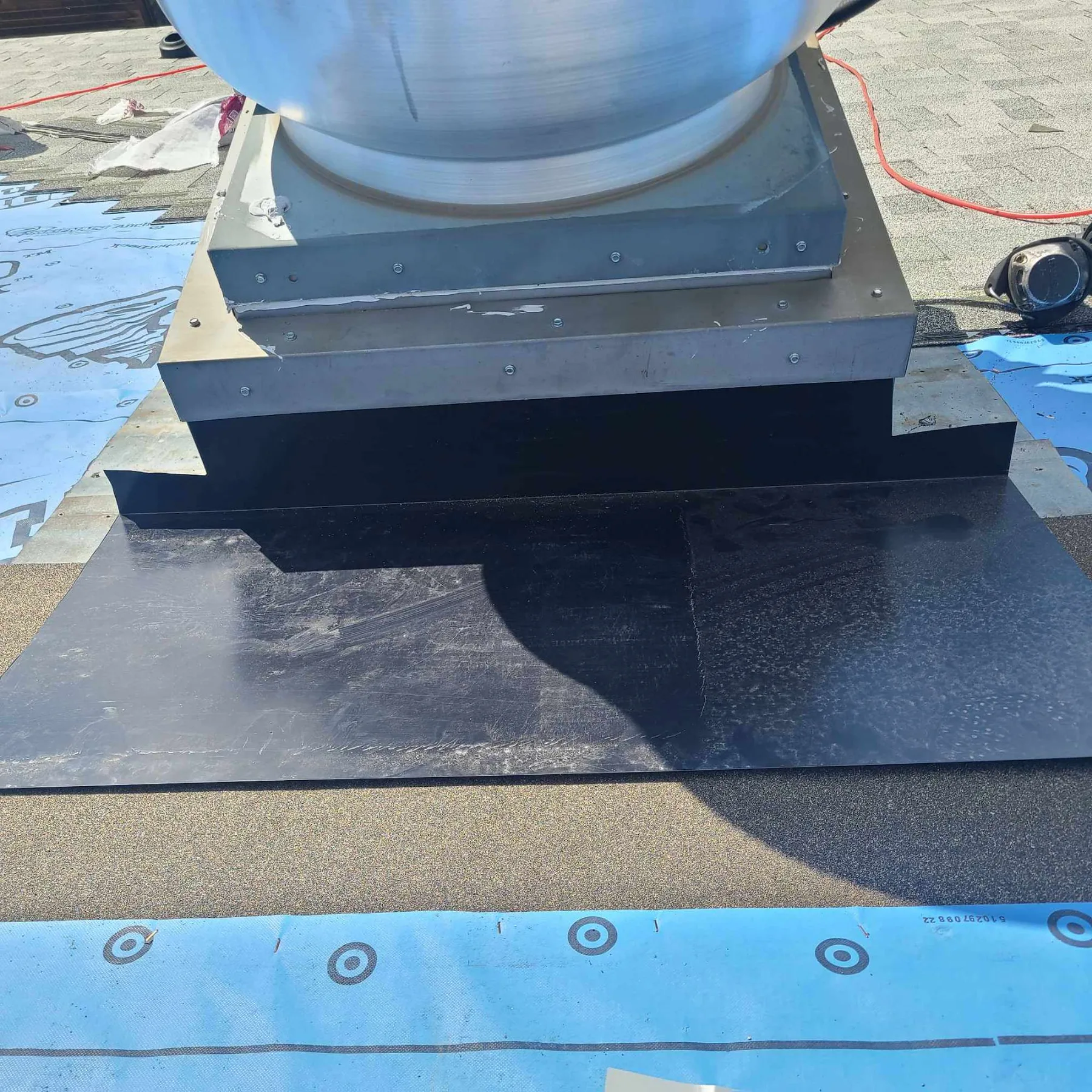 New curb flashing and membrane around a rooftop unit on a commercial roof in High River, AB
