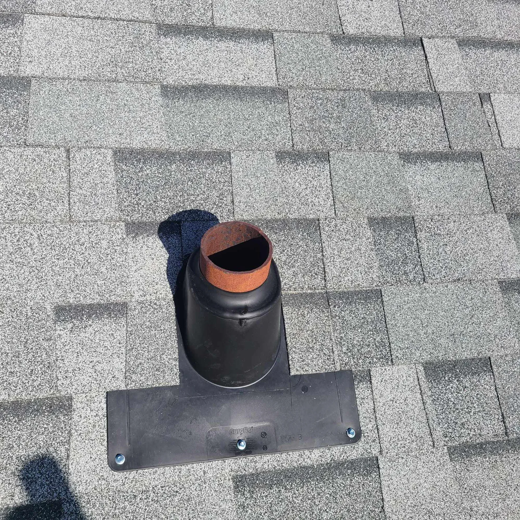 New pipe flashing on a commercial shingle roof in High River, AB