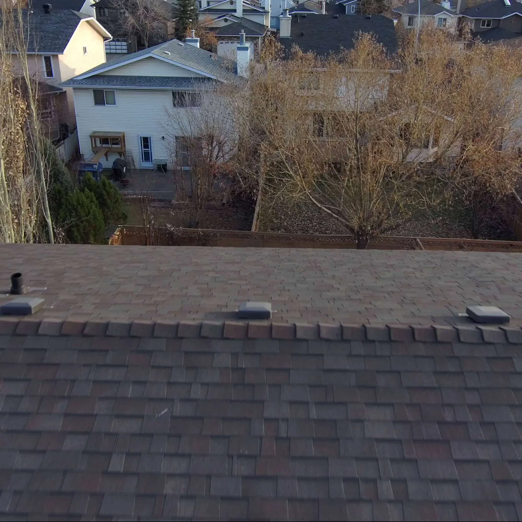 Close-up of new ridge cap, roof vents and architectural shingles on a Riverbend, Calgary roof