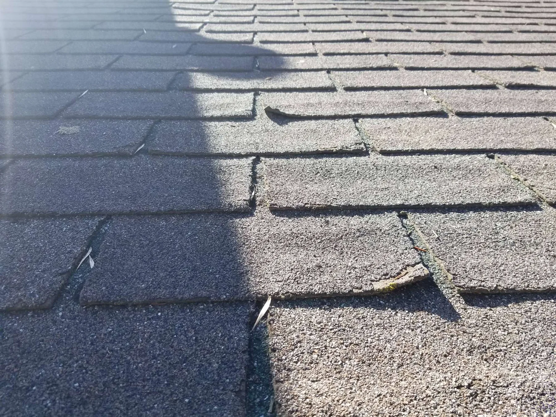 Worn, cracking original asphalt shingles on a Riverbend, Calgary roof