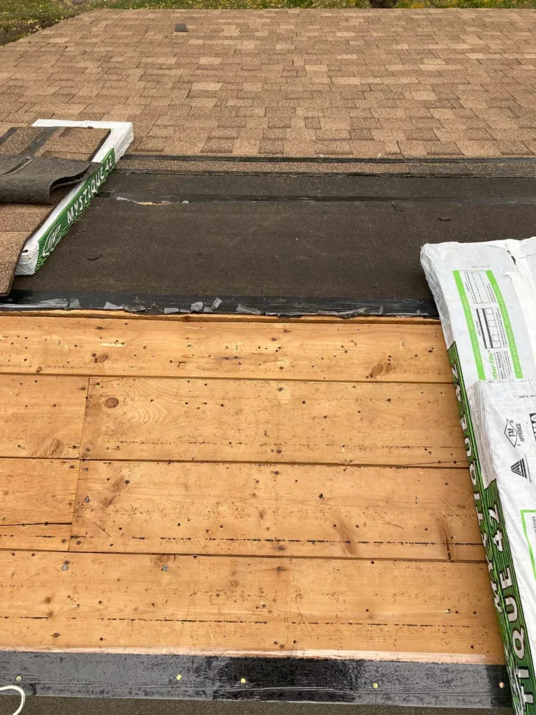 New roof deck sheathing installed before underlayment during a roof replacement