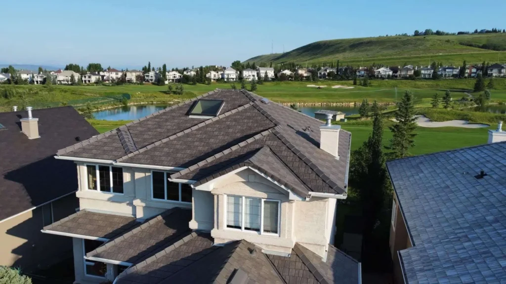New recycled rubber shake roof on a two-storey home in Cochrane, AB, with the golf course and hills behind