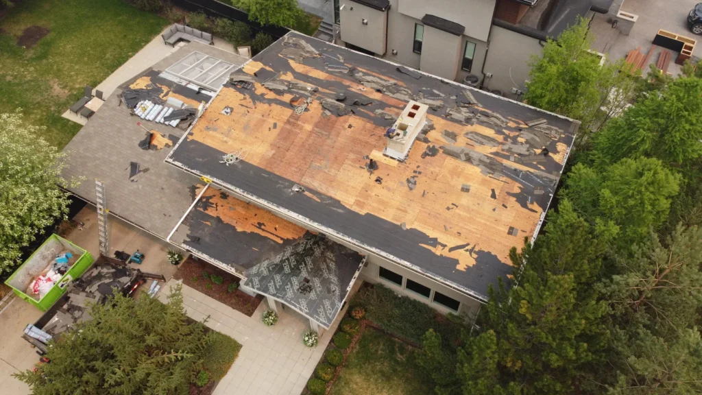Roof tear-off down to the deck before new underlayment, drone view
