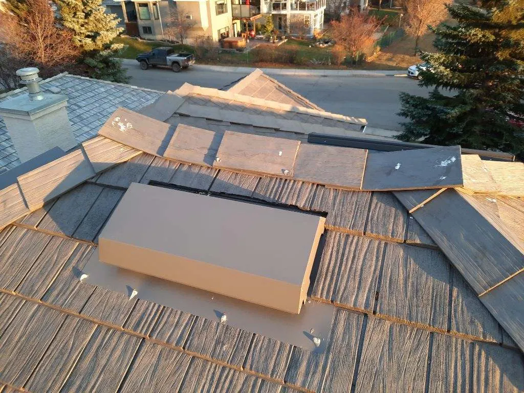 Roof vent and flashings checked during a roof maintenance visit in Cochrane, AB