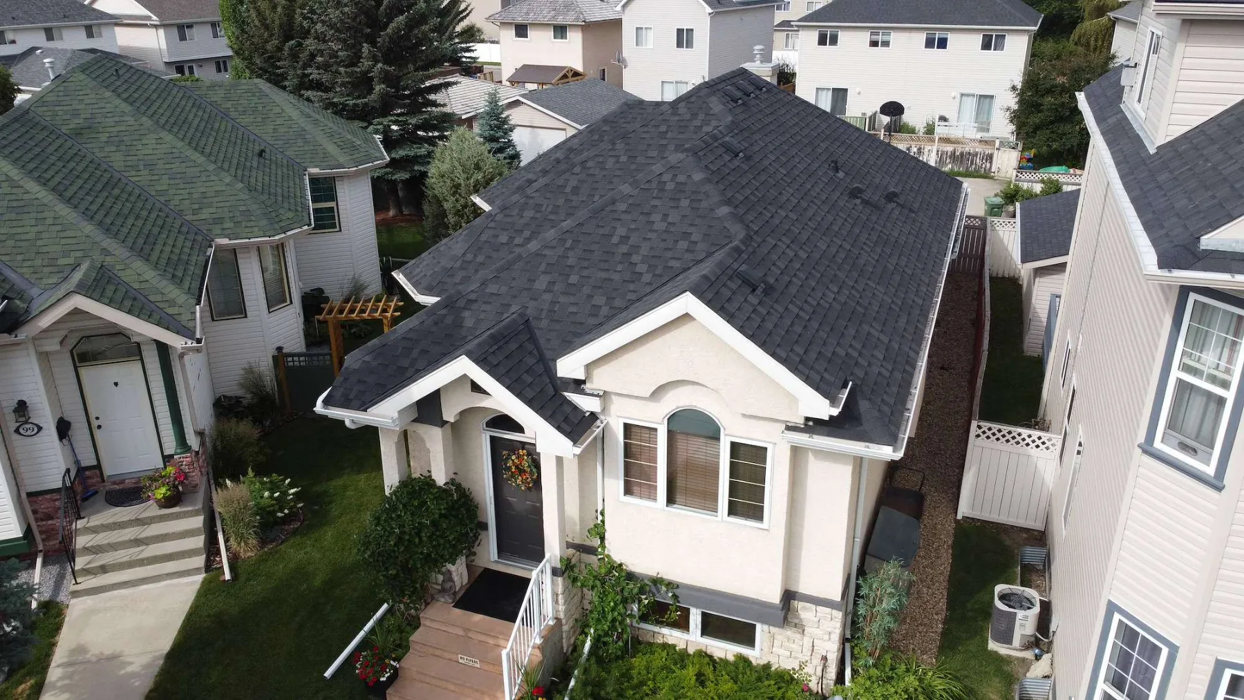 New dark shingle roof on a stucco home in south Calgary, seen from above