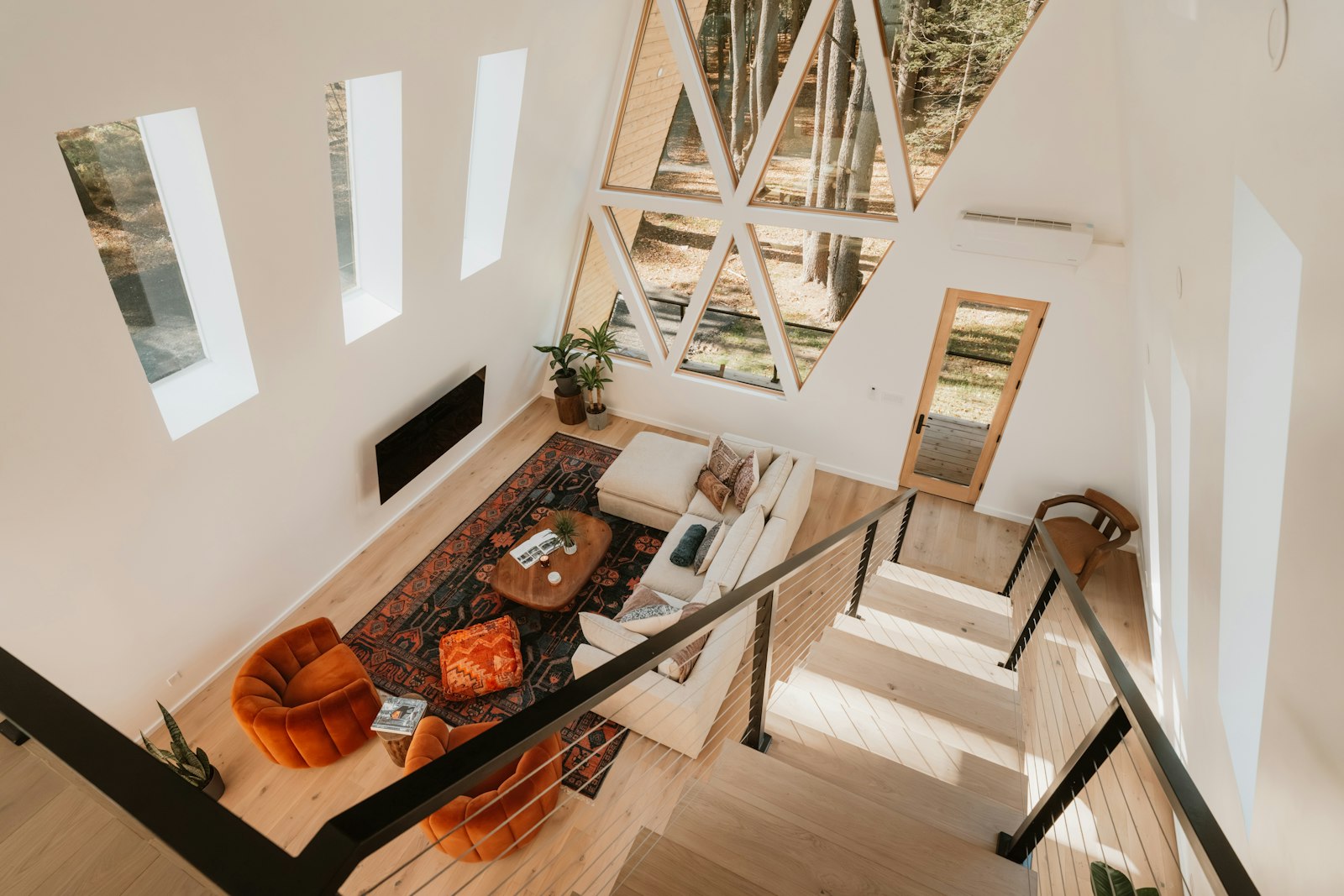 A-frame cabin living room with a large geometric window wall
