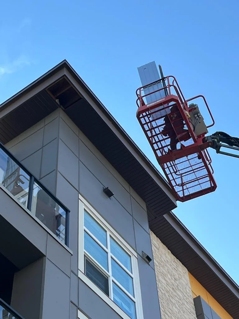 Working from the manlift on the condo, Calgary, AB