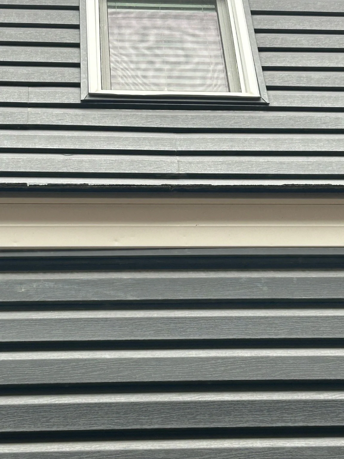 Hail-damaged vinyl siding, Calgary