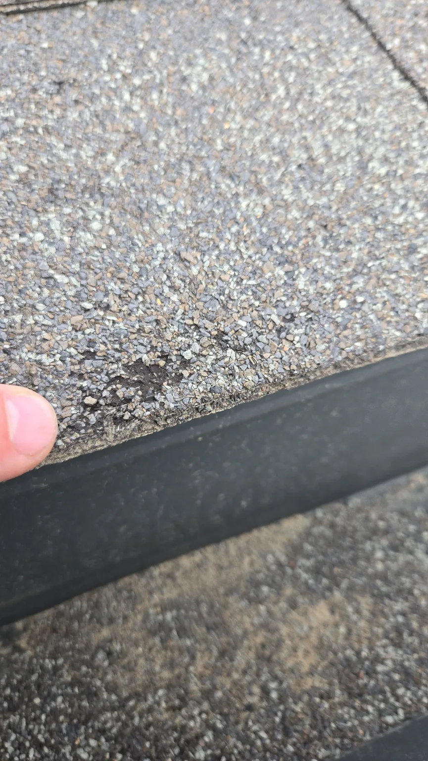 A hail-dented eavestrough, Calgary
