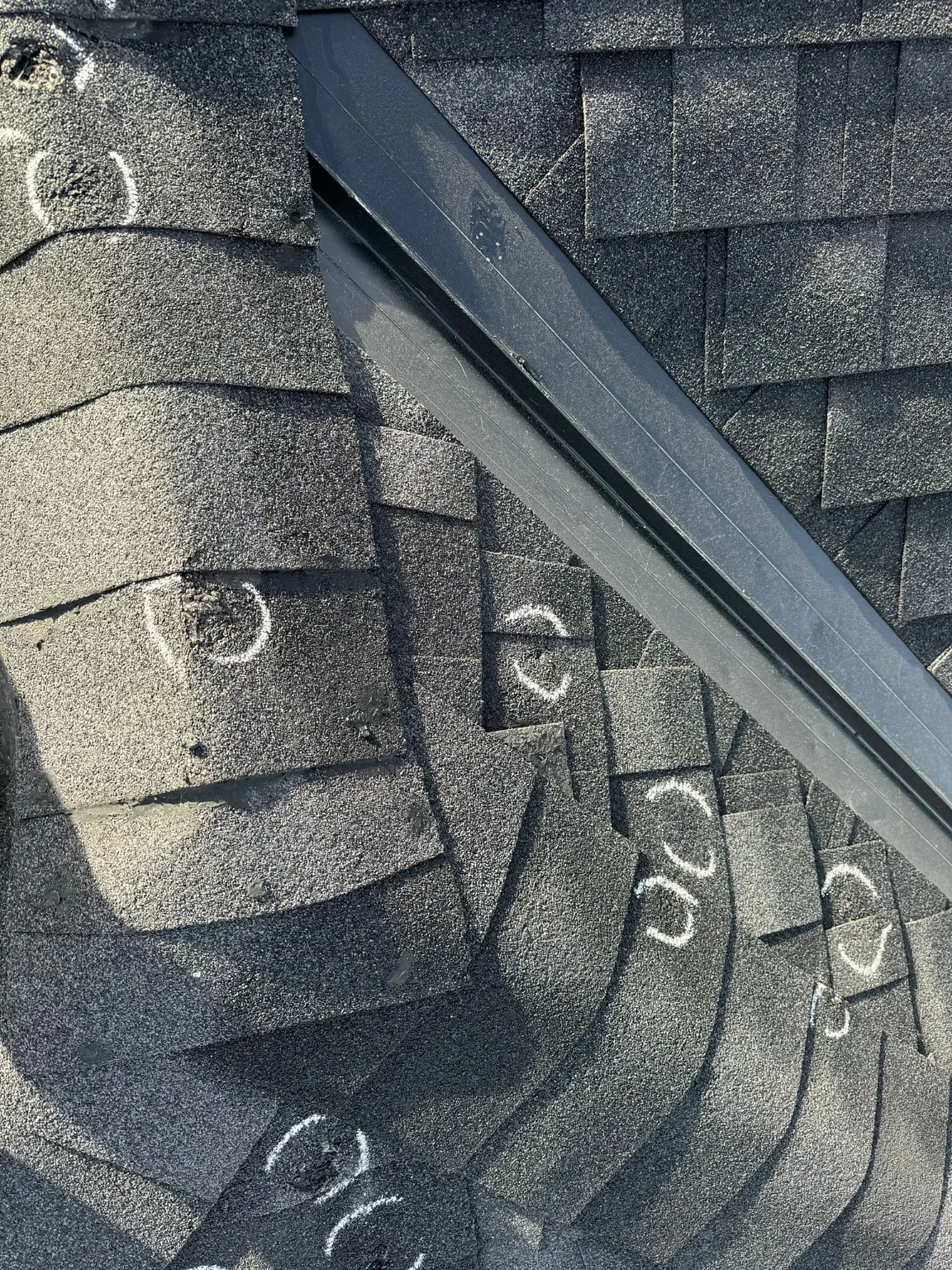 Hail hits marked along a roof hip, Calgary