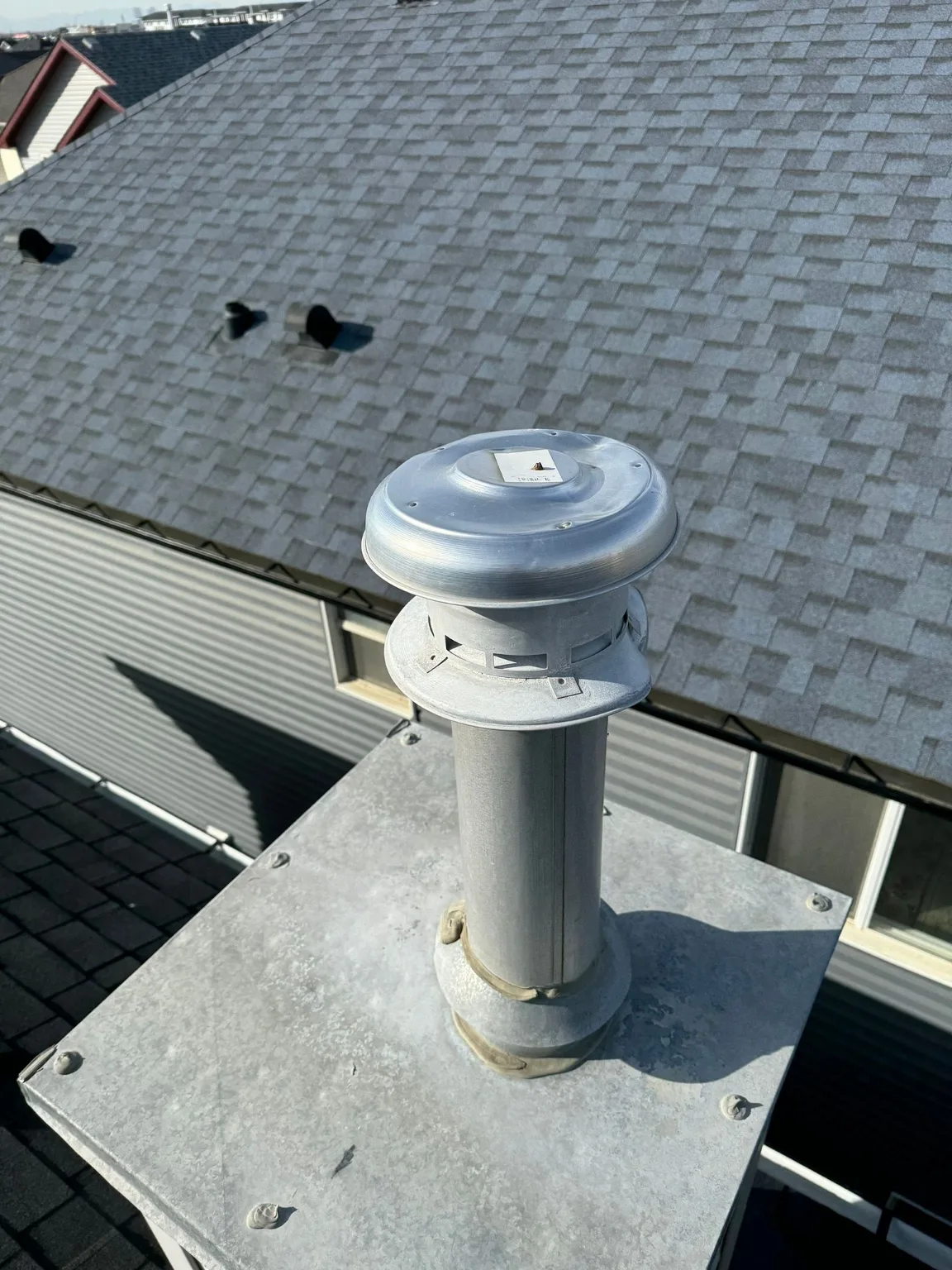A roof vent cap checked for hail damage, Calgary