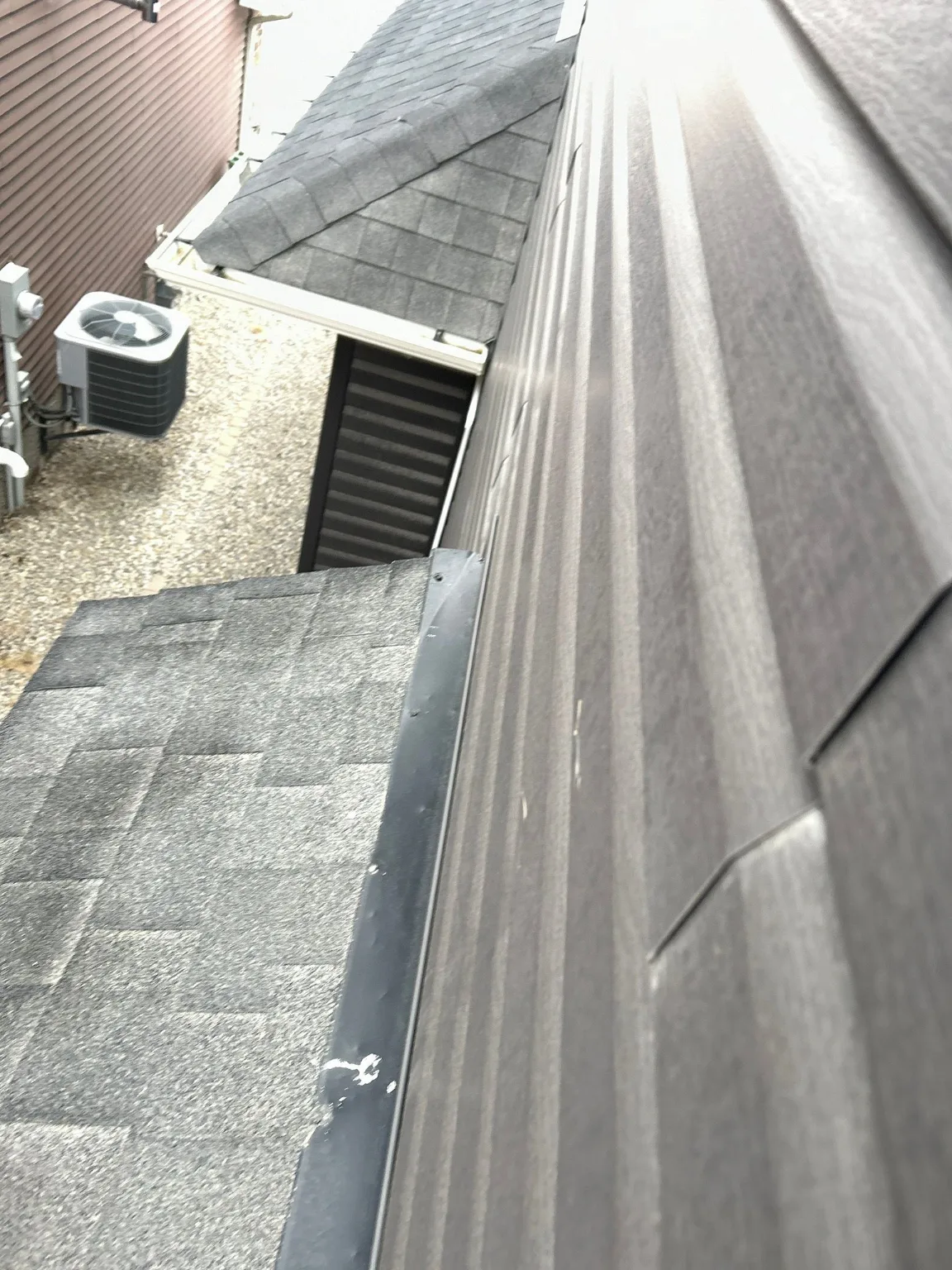 Metal and siding where the roof meets the wall, Calgary