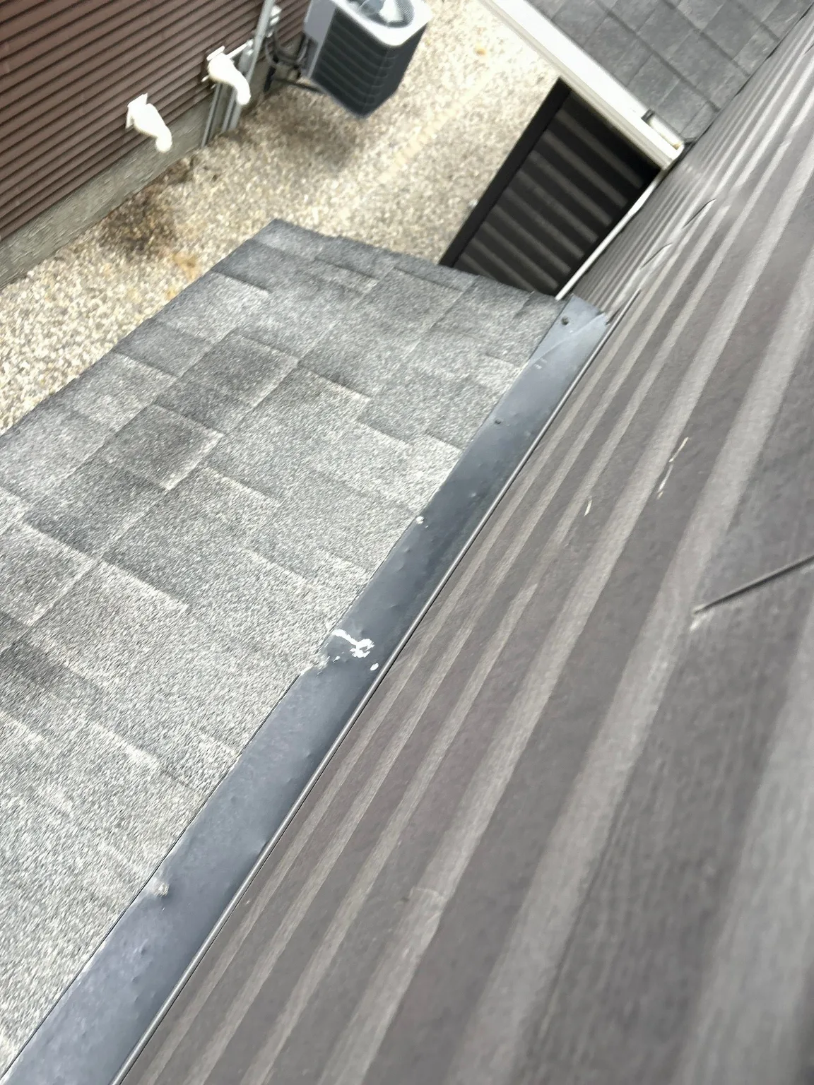 Roof-to-wall flashing at a leak point found during a hail inspection, Calgary
