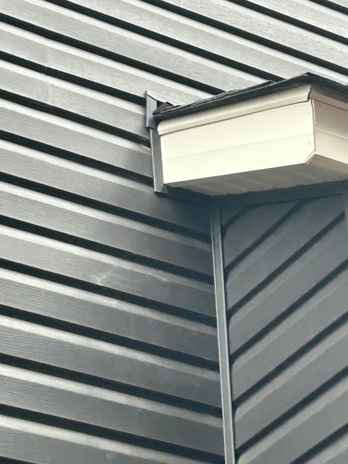 Siding and soffit corner after hail, Calgary