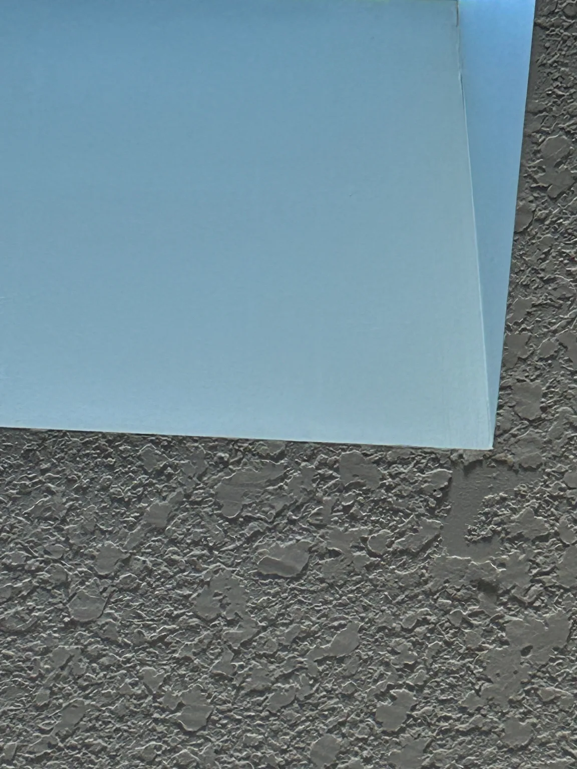 Where siding and stucco meet, checked after hail, Calgary