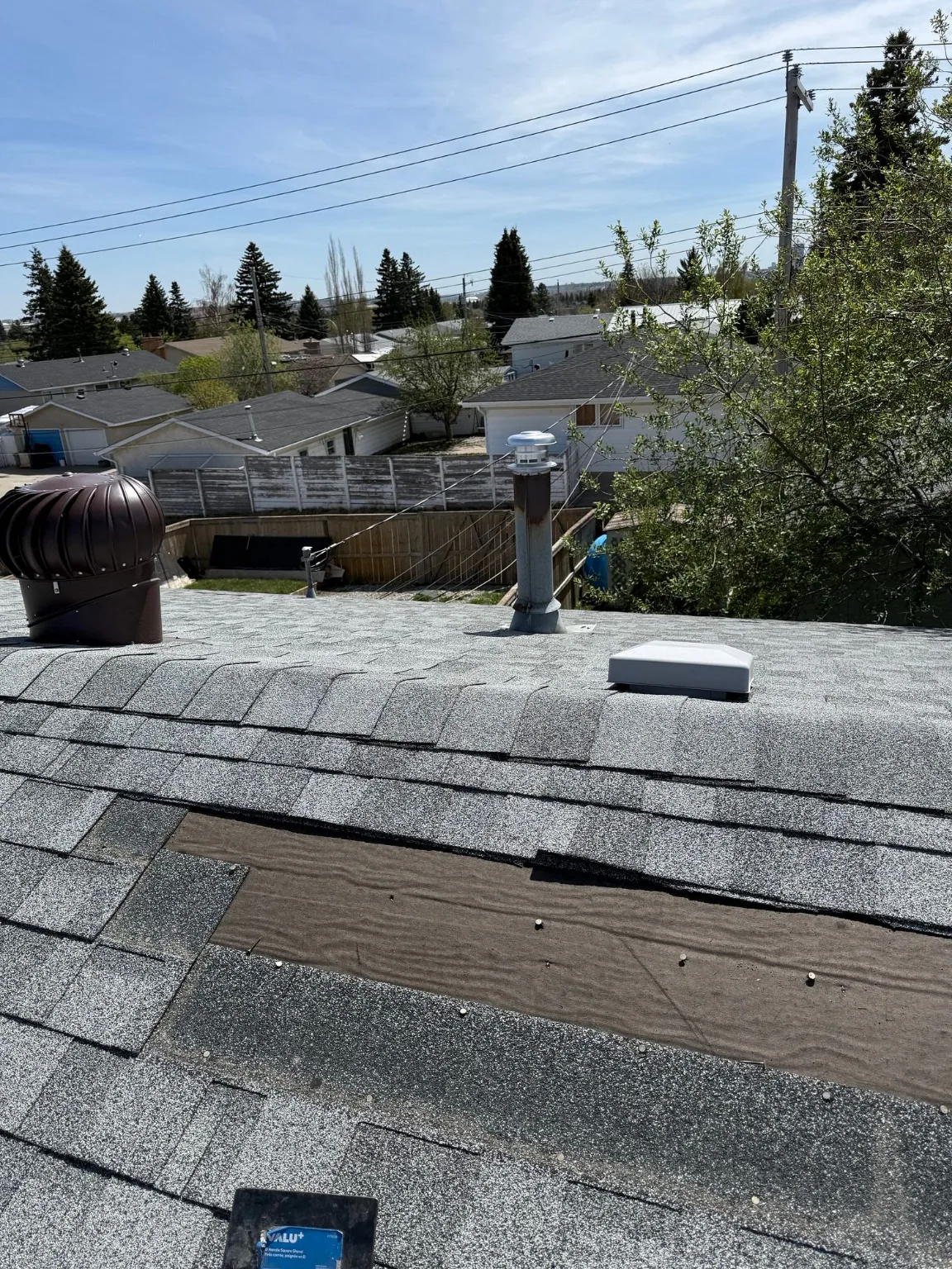 Exposed roof deck along an upper slope after wind, Calgary