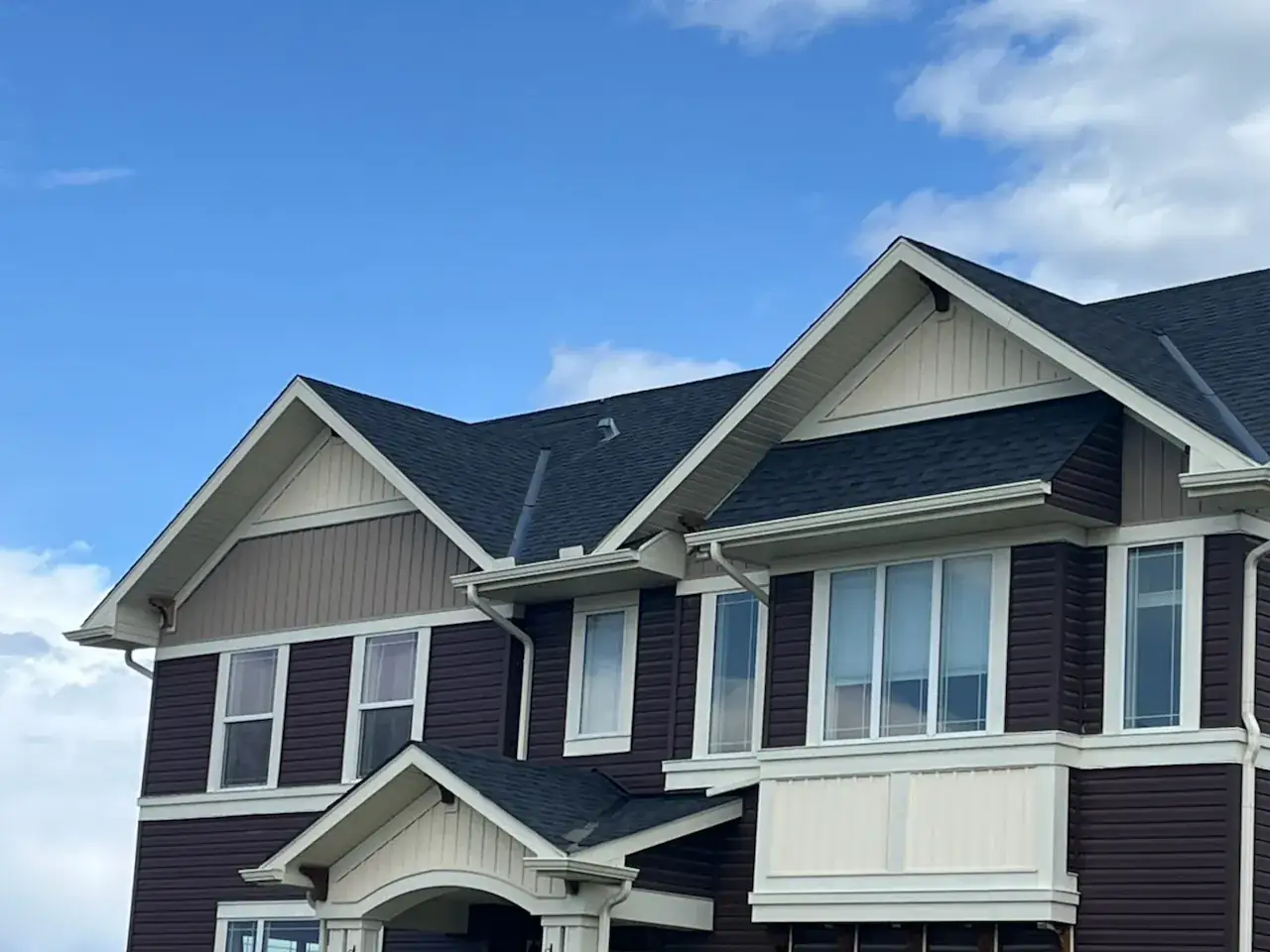 Asphalt shingle gables and siding on a family home