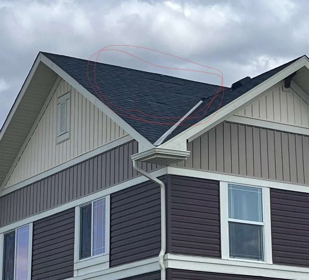 Wind-lifted shingles marked during a roof inspection