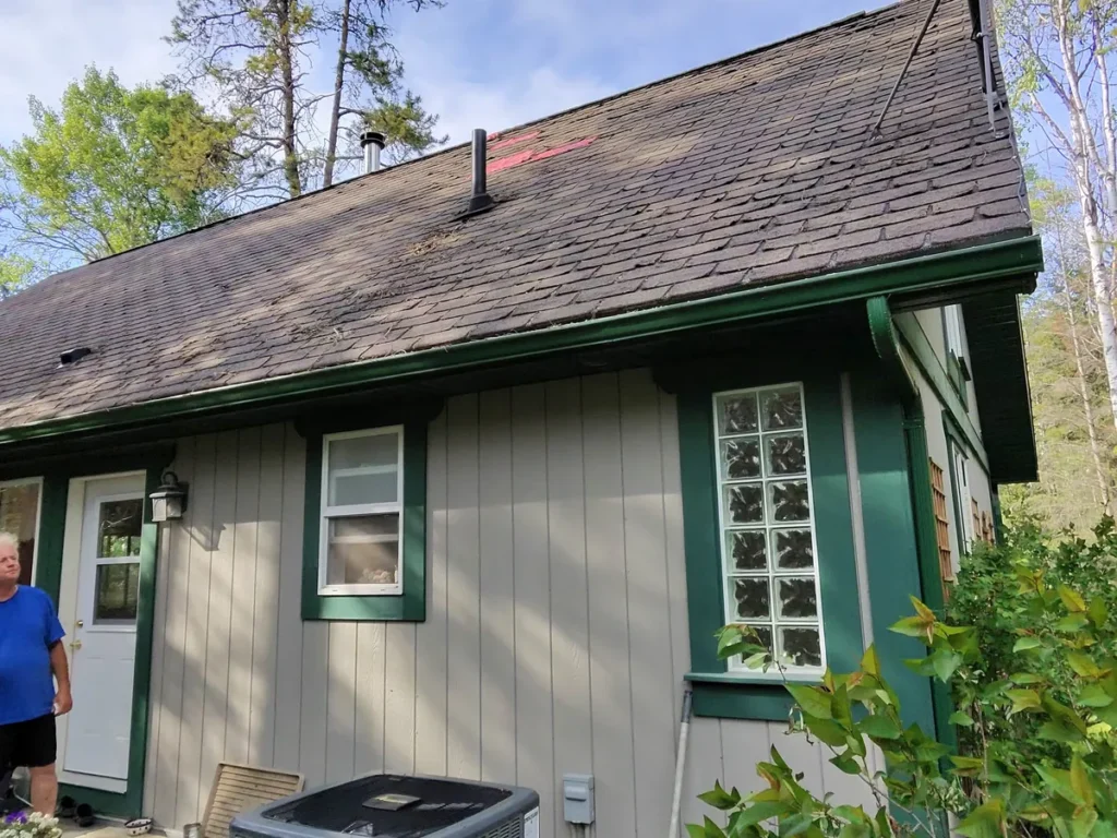 Shingle roof and eaves on an Edgewater cabin before replacement
