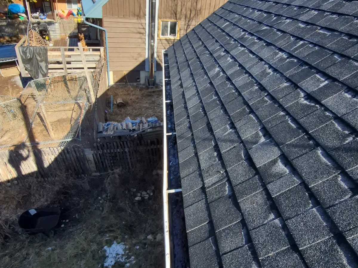 Eavestrough along a new shingle roof edge in Edgewater