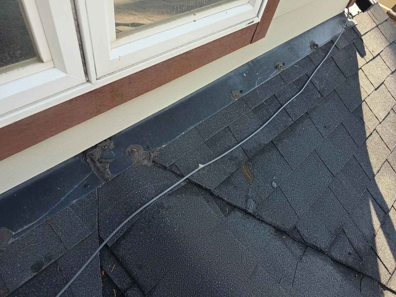 Worn shingles below a window, Edgewater, BC
