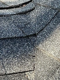 Curling shingle edges on an older roof, Elbow Park, Calgary, AB