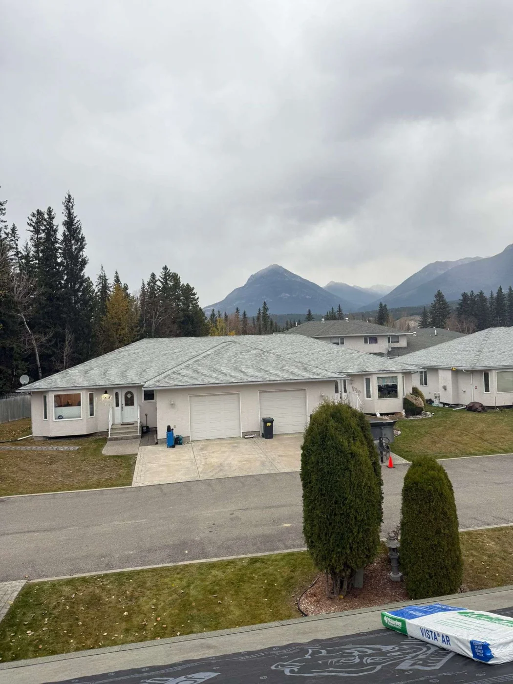 Duplexes at the strata complex with their new roofs and the Rockies behind