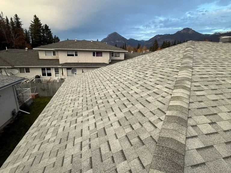 New shingle roof on a Golden strata building with the Rockies behind
