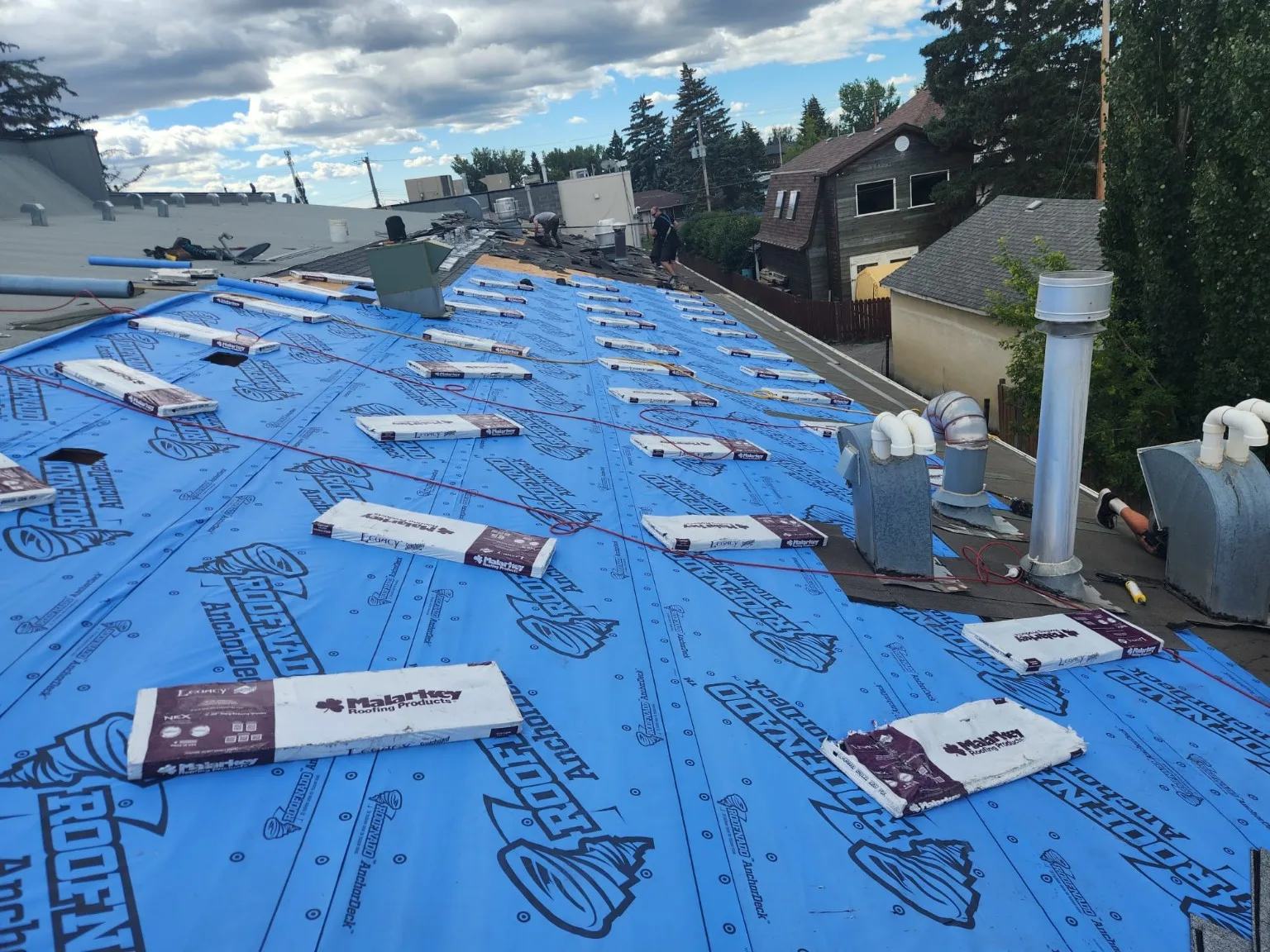 New underlayment on a commercial sloped roof, High River