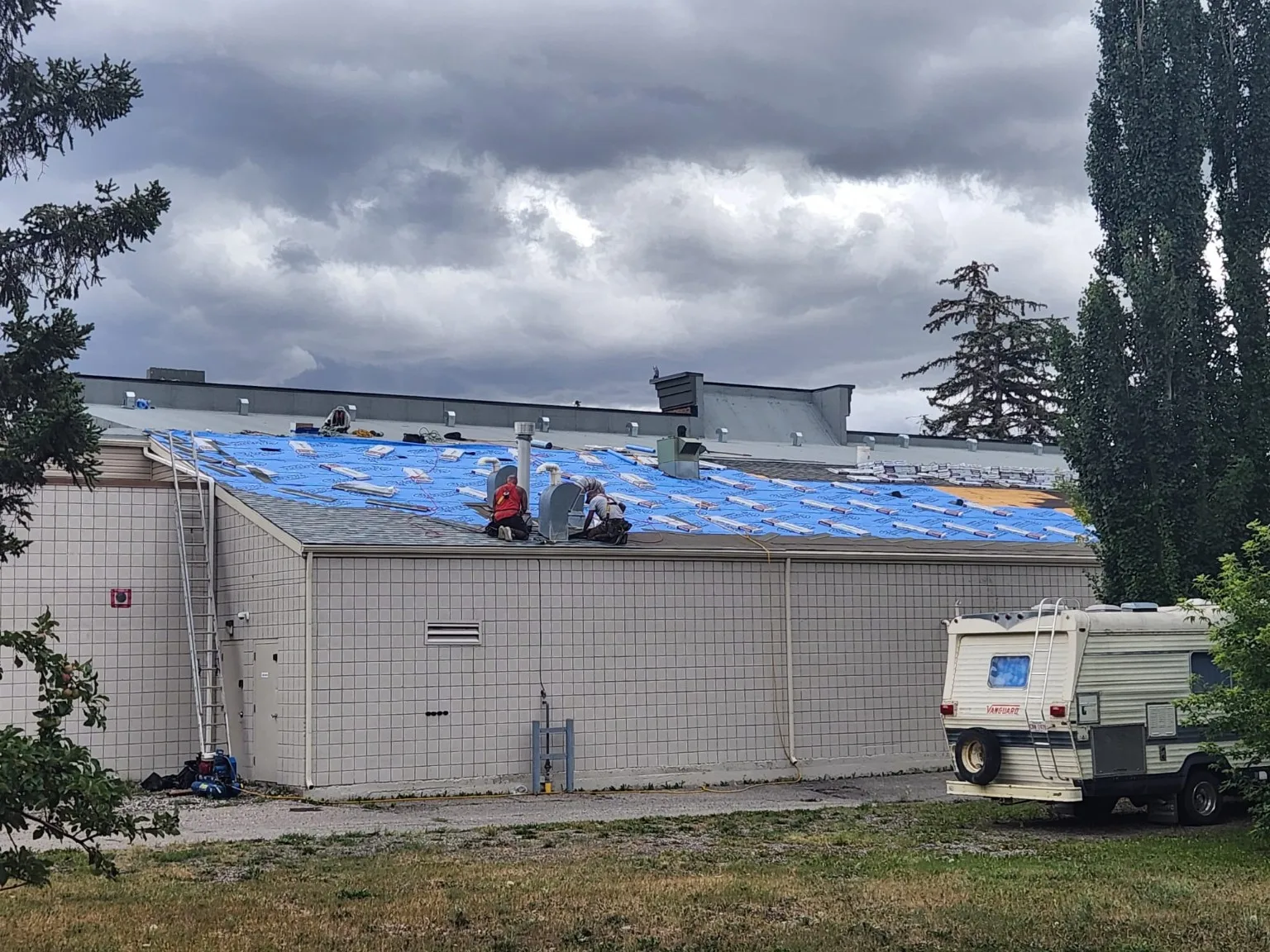 Crew re-roofing a commercial building in downtown High River