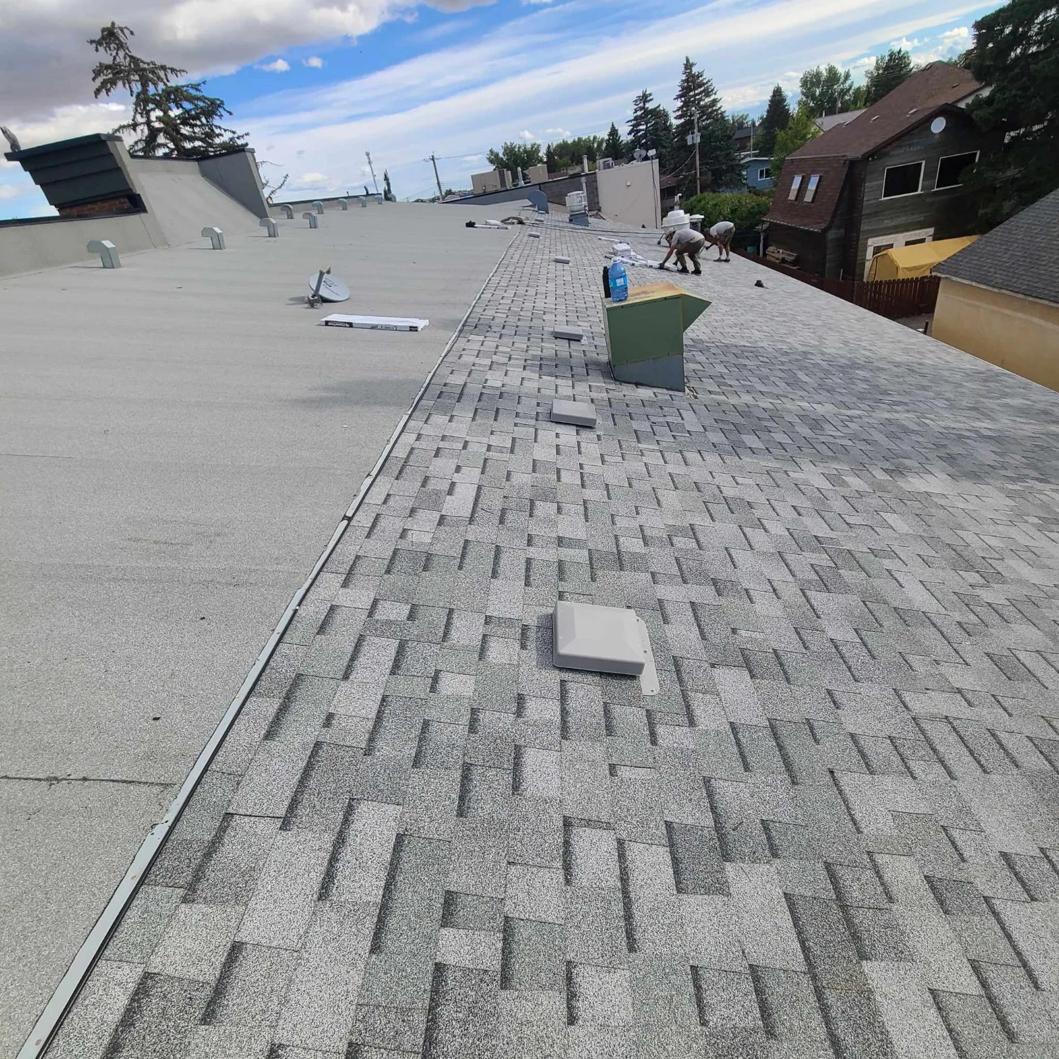 A finished sloped roof beside the flat SBS roof, High River