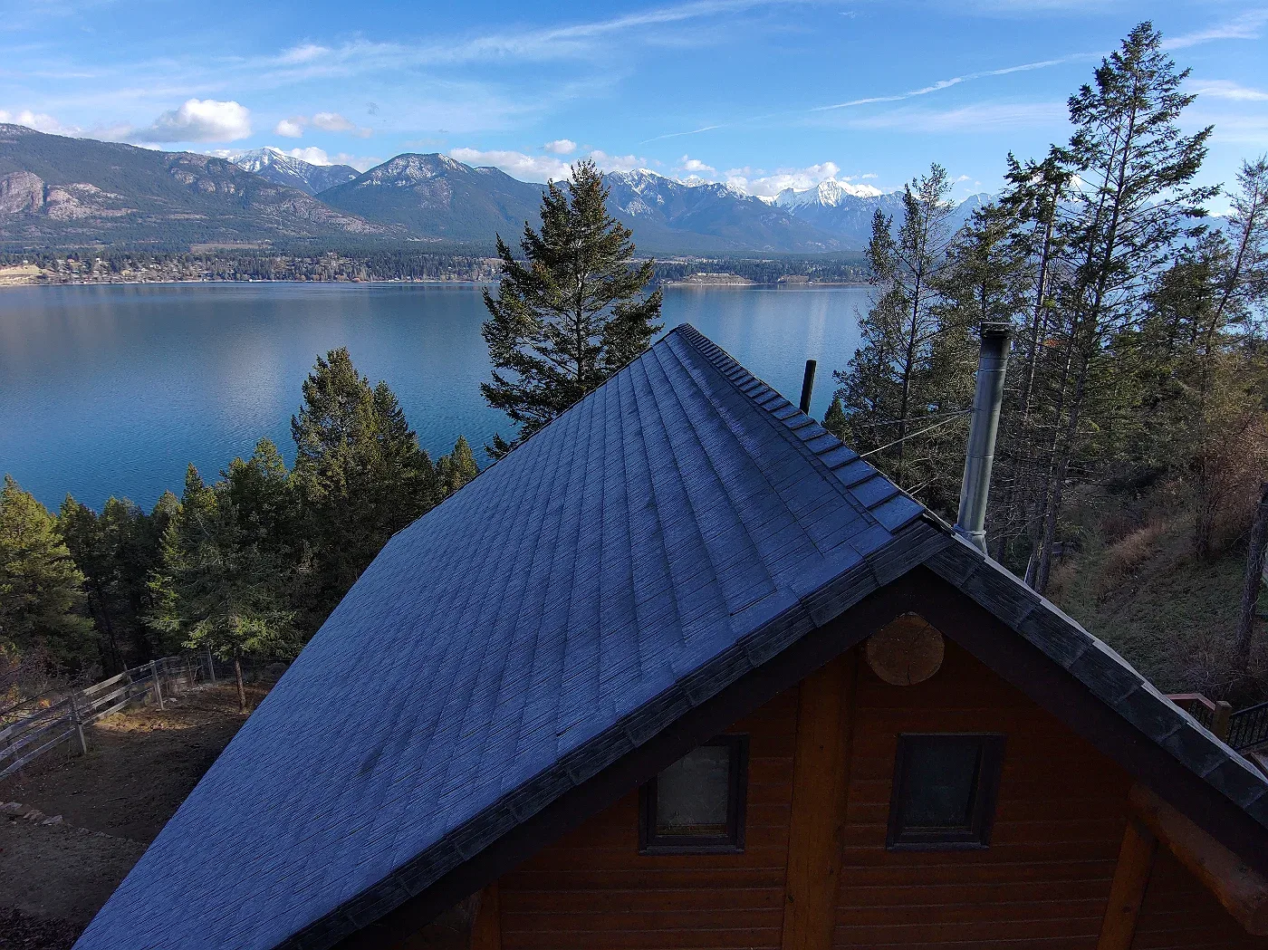 Gable end of a log A-frame cabin with a new rubber roof, Invermere, BC