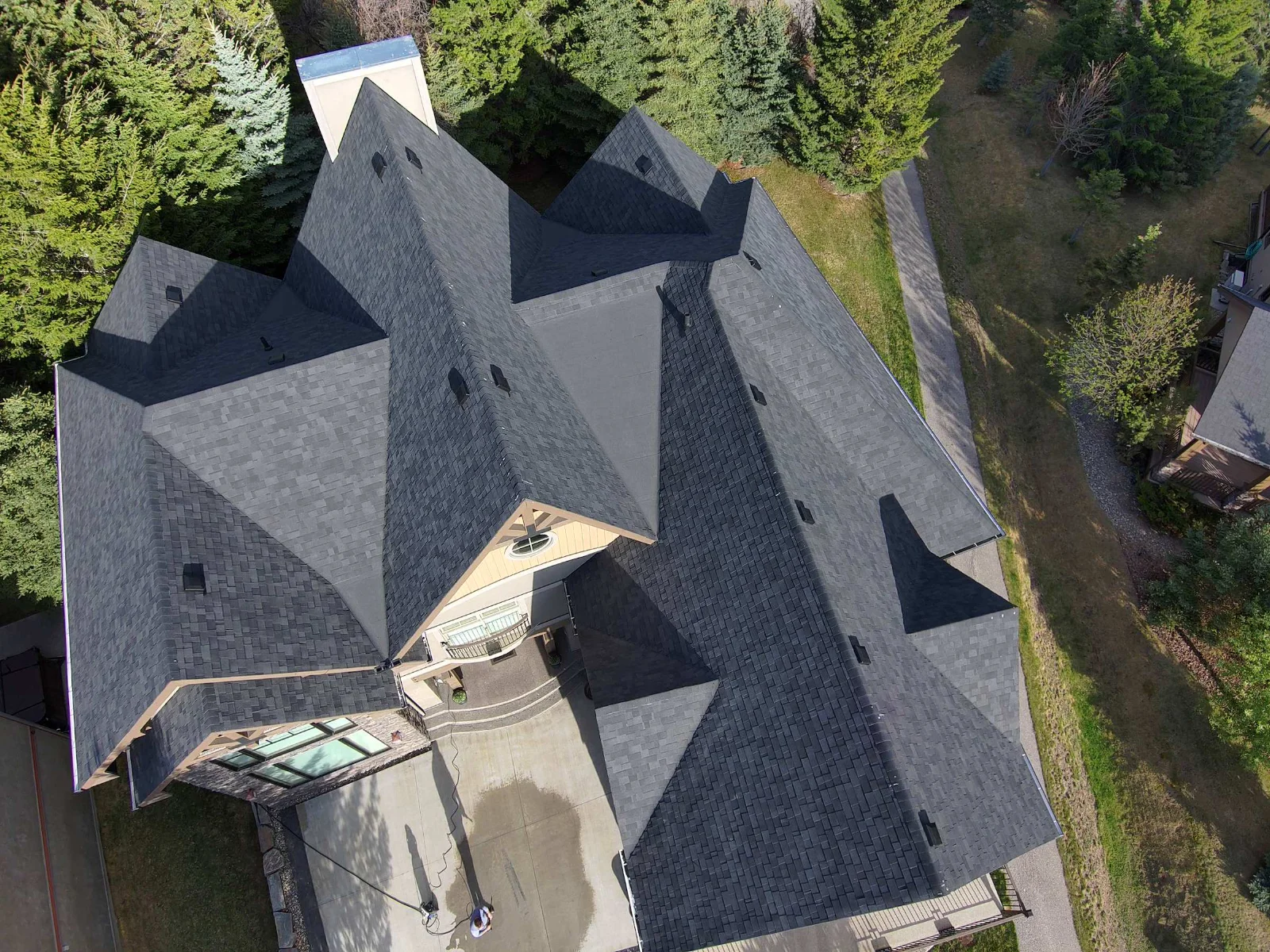 Overhead view of the finished roof showing its many hips, valleys and dormers, Invermere, BC