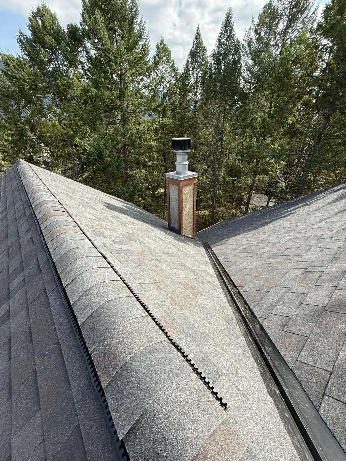New shingles around the chimney on the finished roof, Invermere, BC