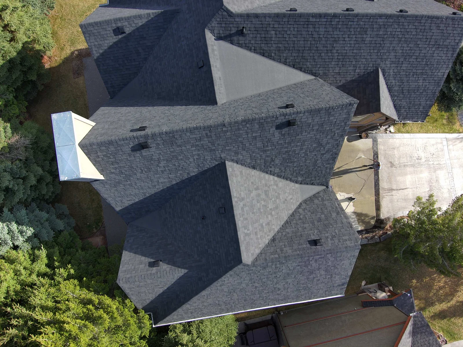 Close overhead view of new hip and ridge caps on the finished roof, Invermere, BC