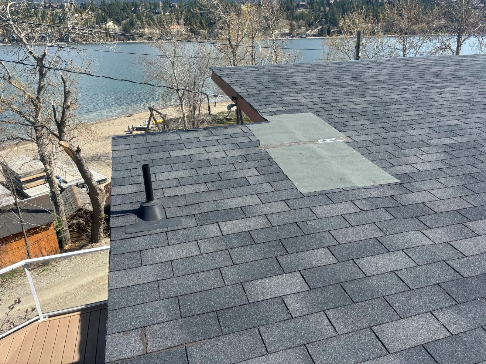 The old low-slope shingle roof with patched areas, Invermere, BC