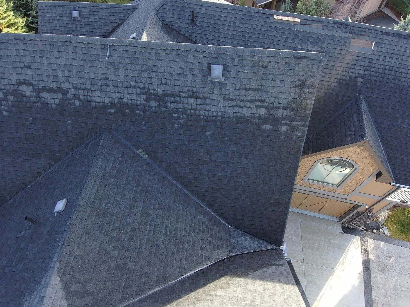 Close-up of worn, faded shingles on the old roof before replacement, Invermere, BC