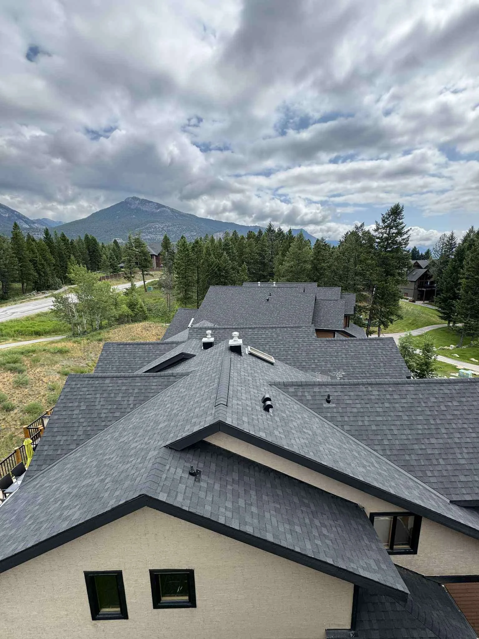 The new roofs across the complex with the mountains behind, Invermere, BC