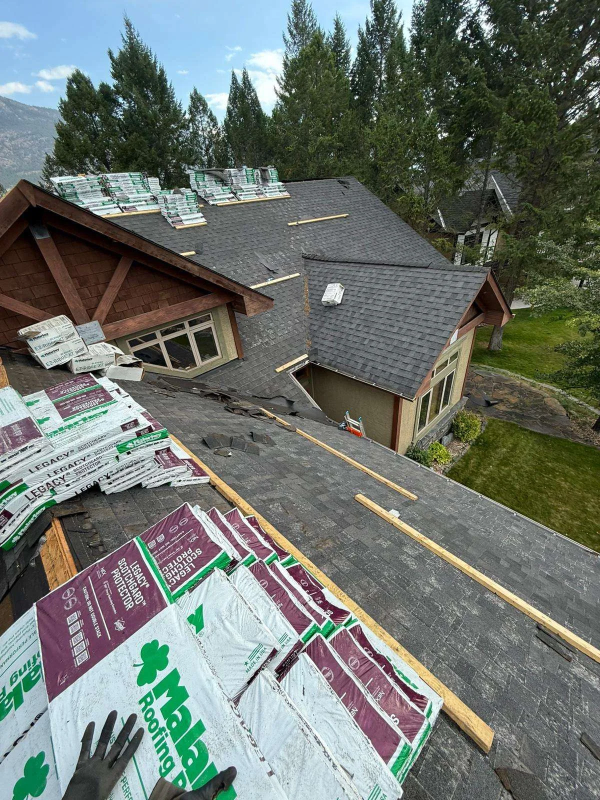 Original shingles still on the roof with the new Malarkey Legacy bundles loaded, before tear-off, Invermere, BC