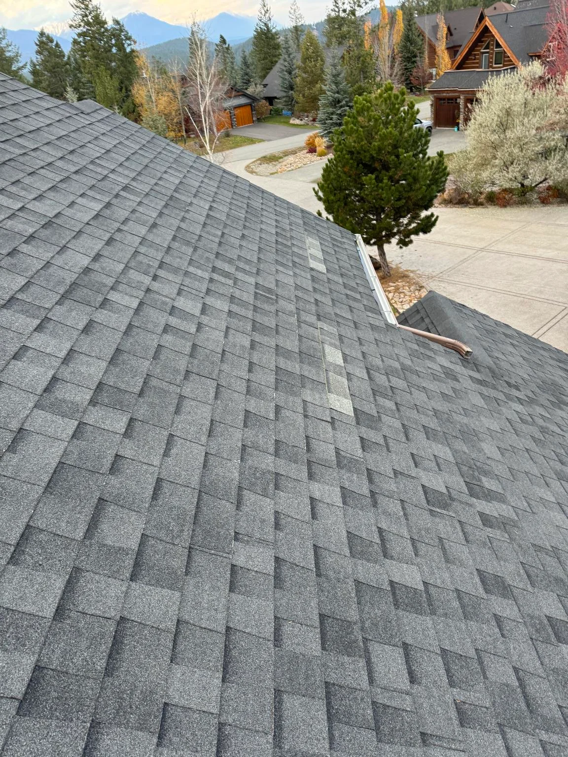 Patched shingles on a steep slope, Invermere, BC