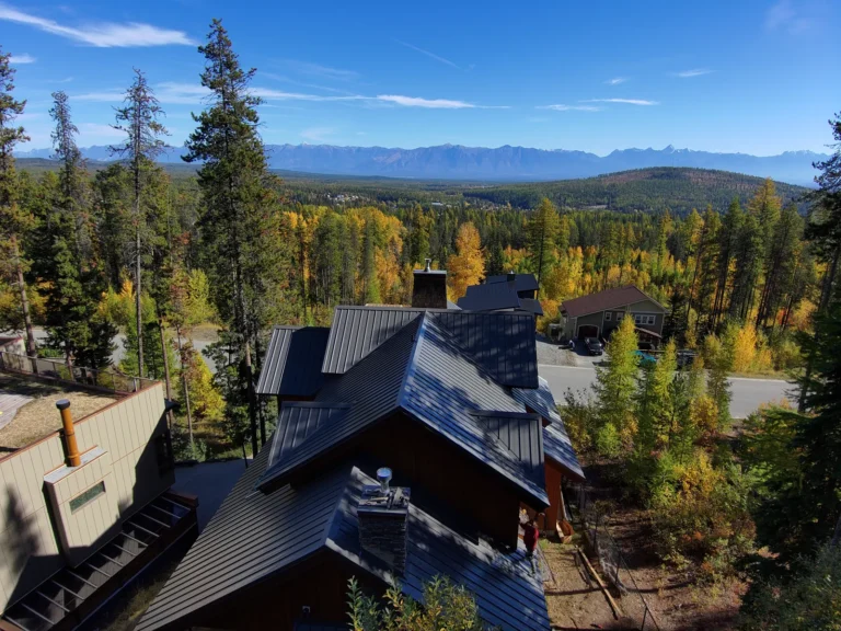 New standing-seam metal roof on a Kimberley home with the Rockies behind