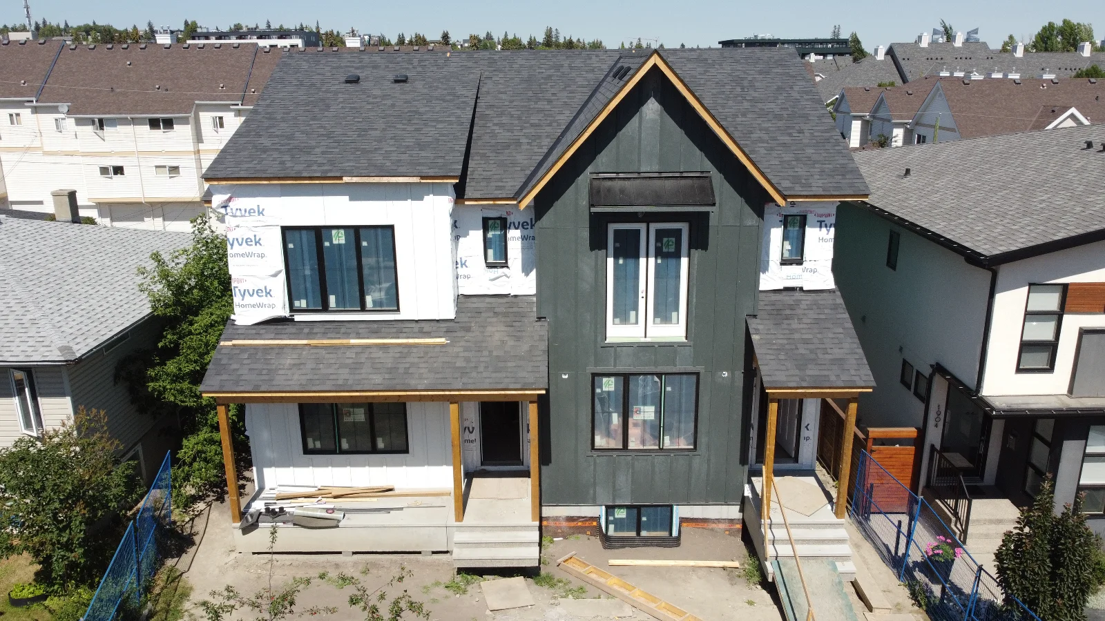 Aerial view of the dark and white James Hardie board-and-batten siding on a Marda Loop infill