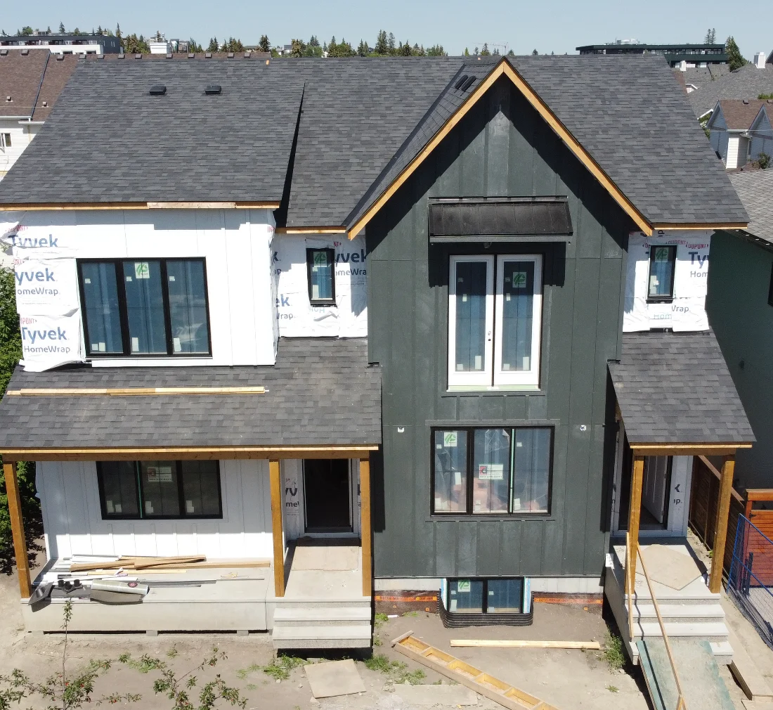 Dark James Hardie board-and-batten siding on a two-storey home in Marda Loop, Calgary