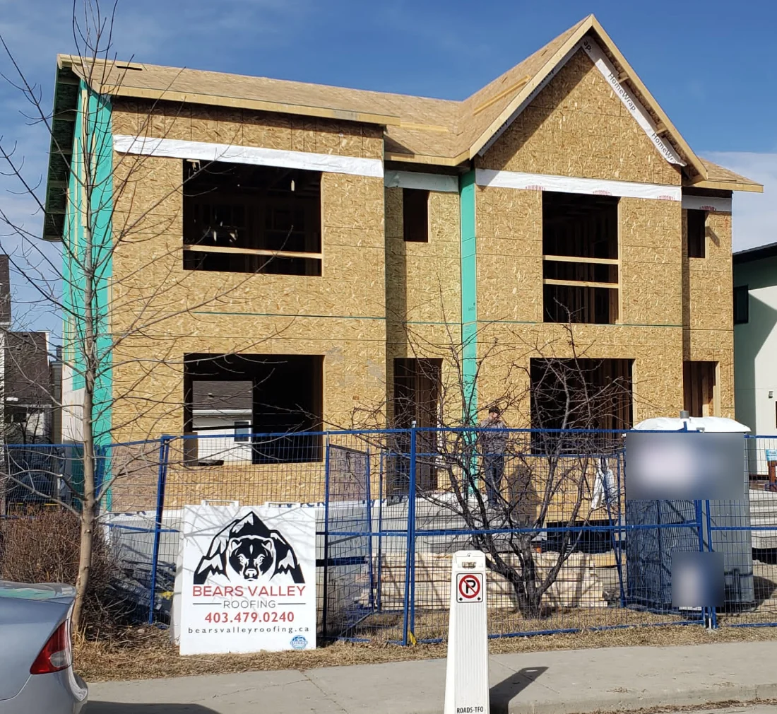 Front of the Marda Loop infill home in bare sheathing, before the James Hardie siding went on
